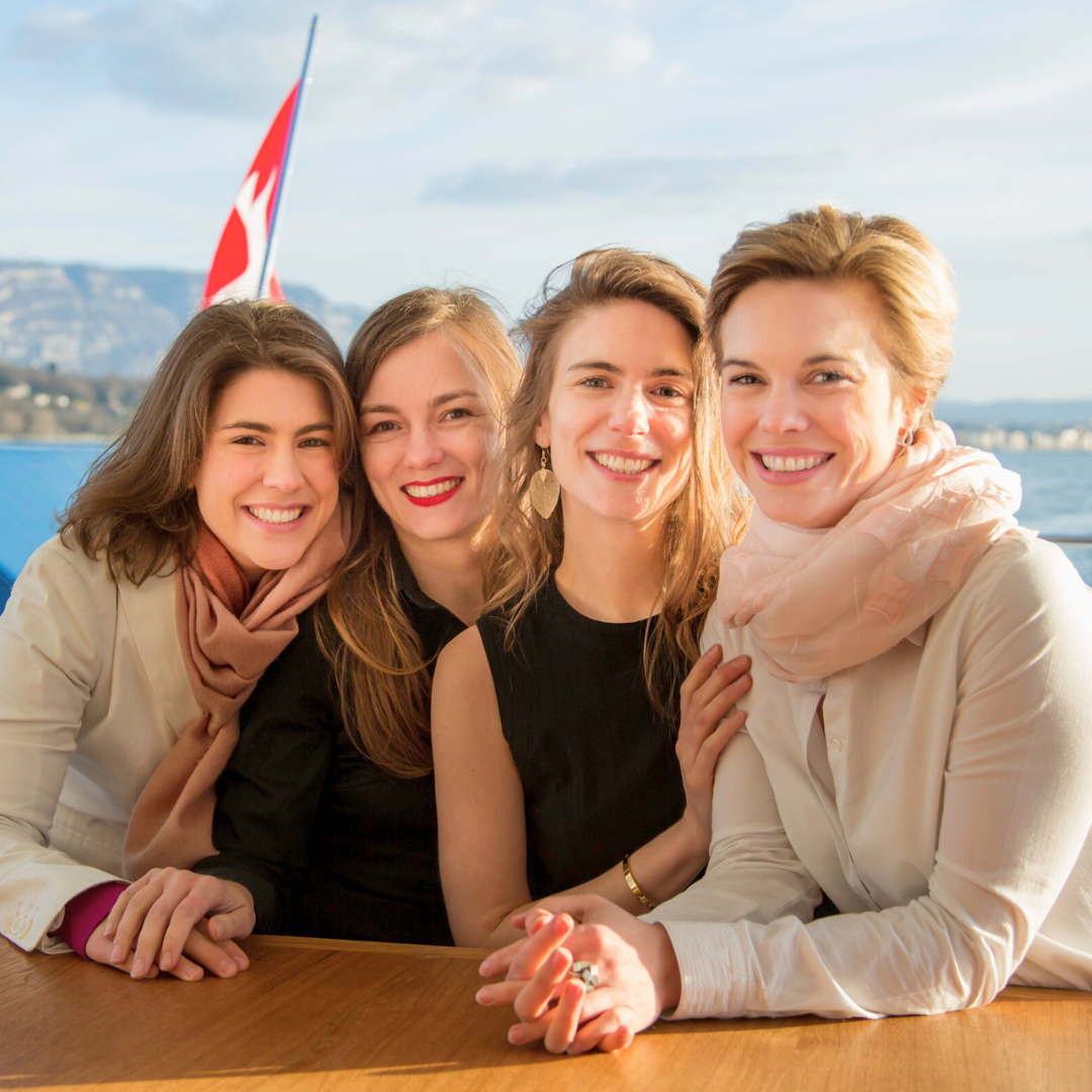 Polla Sisters on a boat in  Lake Geneva with a Swiss Flag in the background.  Swiss Beauty Secrets: Your Guide to Radiant Skin with Alchimie Forever