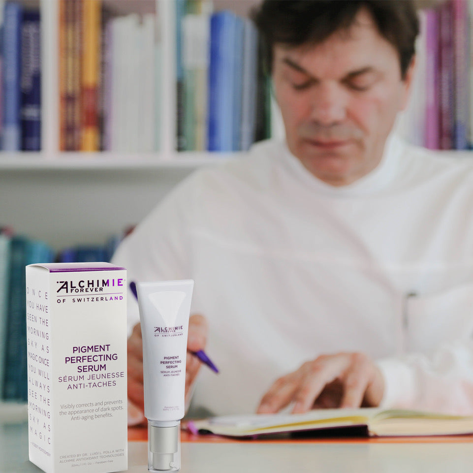 Dr. Luigi Polla at his desk with a bottle of Alchimie Forever Pigment Perfecting Serum.