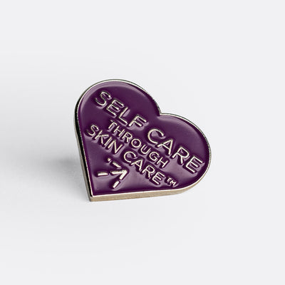 Alchimie Forever's brand new "self care through skin care" purple heart pin.